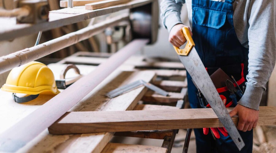 a person using a saw to cut wood
