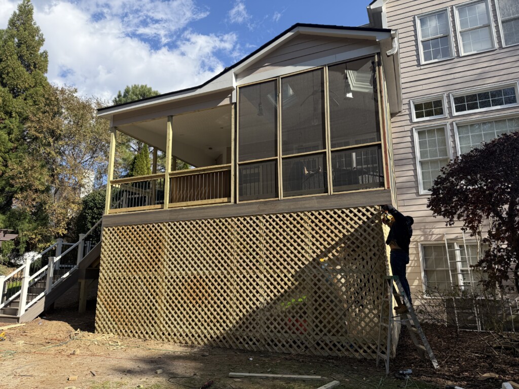 a man on a ladder on a porch