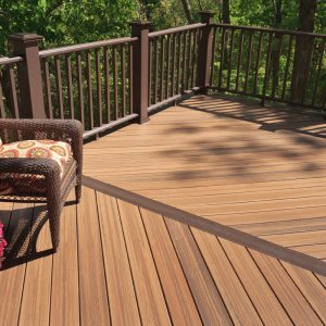 a deck with a chair and a railing
