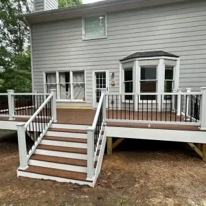 Raised Trex Composite Deck with White Railings and Black Balusters Raleigh